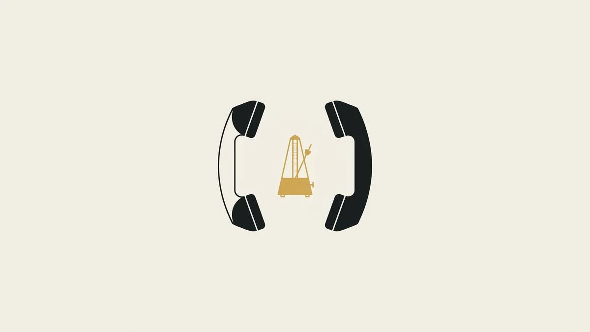 Two black telephone handsets facing each other on bone paper, with a small gold metronome standing in the gap between them