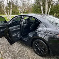 A shiny black car with the doors open