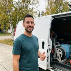 Luc beside his detailing van