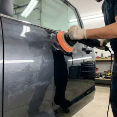 A polisher on a car door