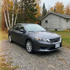 A grey car in a driveway