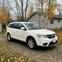 A white SUV in a driveway